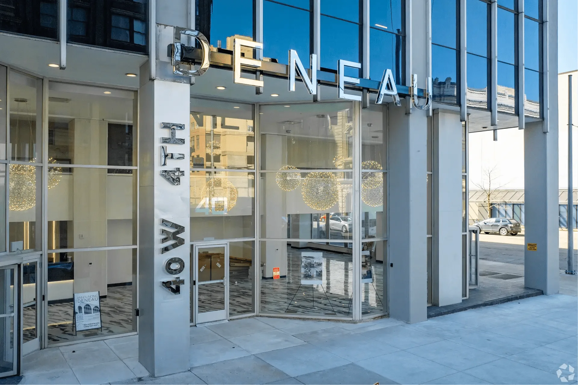 Luxury residential tower entrance at twilight showing premium signage integration