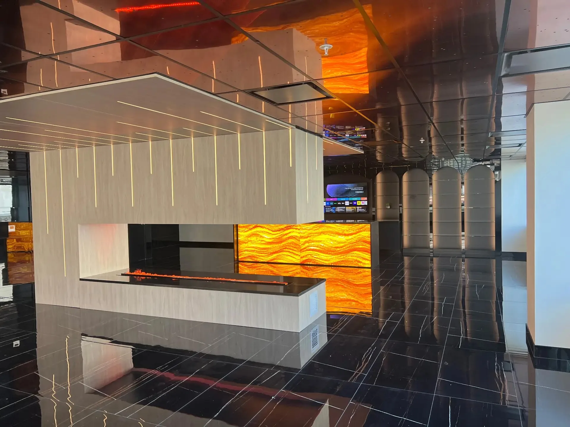 Sophisticated residential lounge with brass laser-cut backlit ceiling and illuminated bar