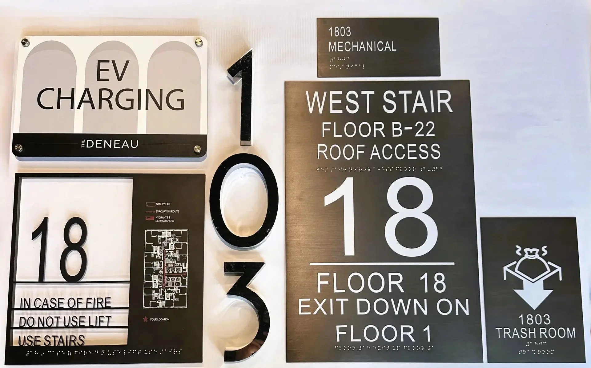 Modern residential lobby with brushed metal floor numbers beside the elevator