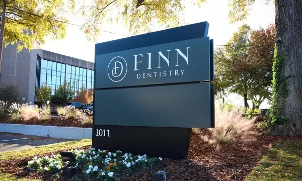 Modern illuminated monument sign at commercial property entrance