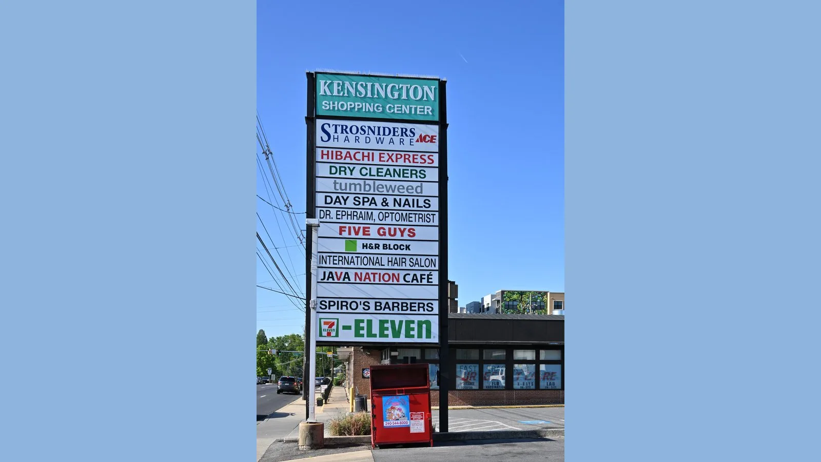Classic multi-tenant shopping center pylon sign along a roadway