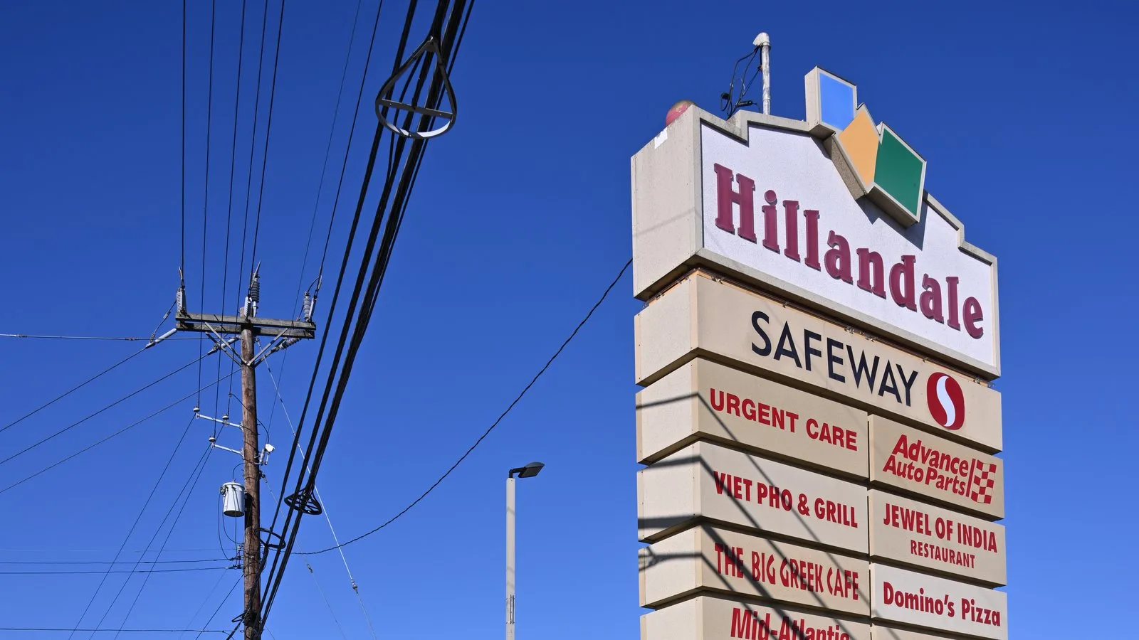 Modern stacked multi-tenant pylon sign with anchor tenant header
